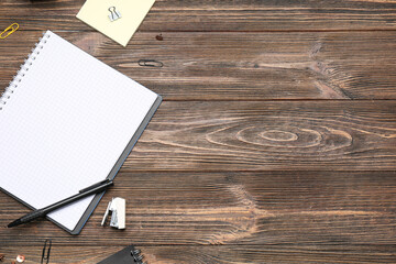 Blank notebook with stationery on wooden background. Rules concept