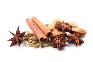 Star anise with cinnamon sticks, cardamom seeds and almond on white background