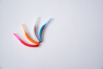 Toothbrushes and interdental brush on the white background. Dental and orthodontic concept.