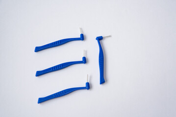 Toothbrushes and interdental brush on the white background. Dental and orthodontic concept.
