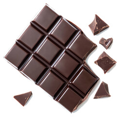 A rectangular bar of dark chocolate with broken pieces nearby