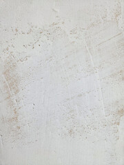 White textured background of putty paste applied with a putty knife with uneven strokes and...