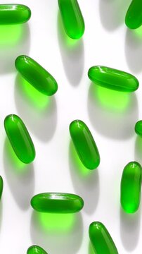 Vitamin e capsules kept on rotating disk. Close up video of vitamin e capsules kept on white background.