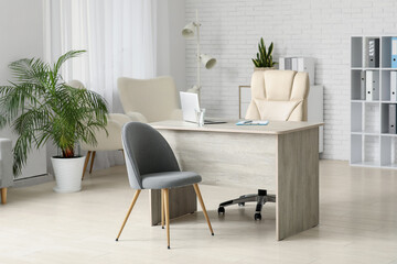 Interior of medical office with doctor's workplace and chairs