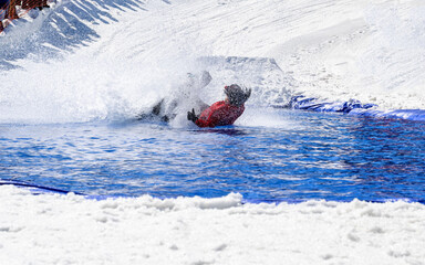People are enjoying Pond skim at the end of ski season	