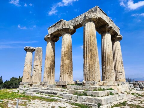 Photo of the Temple of Apollo in ancient Corinth, Greece. Built in the 7th century BC, it is among the earliest Doric temples, showcasing ancient Greek architecture and historical significance.