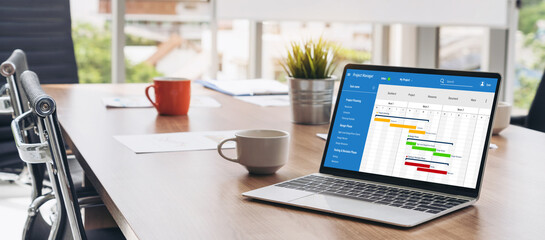 Project planning software for modish business project management on the computer screen showing timeline chart of the team project