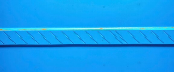 Cool, sharp-edged blue metal surface, industrial texture, lines, detail