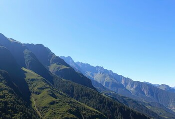 Naklejka premium Lush green mountain range, sunlit peaks, clear blue sky, outdoor, amazing