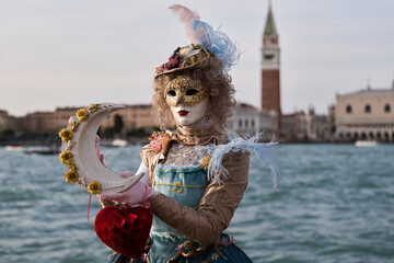 Venice, Italy - People dressed in carnival masks are photographed by tourists in the scenery of the...