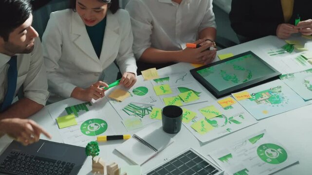 Close up of business people hands write notes about sustainable energy and environmental idea. Group of diverse people taking a note and brainstorming about green tech. Focus on hand. Alimentation.