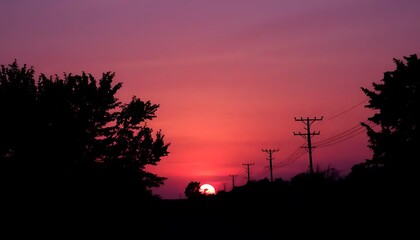 Fiery dawn breaks over a horizon of silhouettes and electric infrastructure