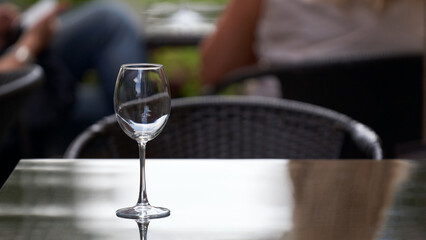 The tasting area at the winery. A single long-stemmed flute of wine on the table.