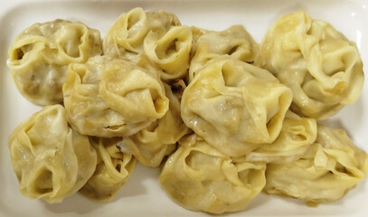 Delicious homemade dumplings served on a white platter for a family meal