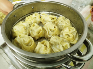 Dumplings steaming in a pot during a cooking session in a home kitchen