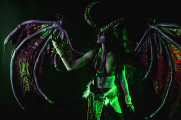 Demon Hunter Demon Cosplay on Black Background in Green Light