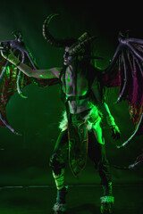 Demon Hunter Demon Cosplay on Black Background in Green Light