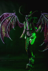 Demon Hunter Demon Cosplay on Black Background in Green Light