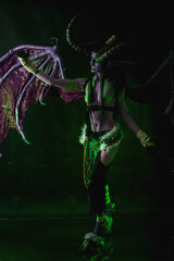Demon Hunter Demon Cosplay on Black Background in Green Light
