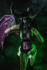 Demon Hunter Demon Cosplay on Black Background in Green Light