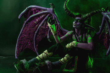 Demon Hunter Demon Cosplay on Black Background in Green Light