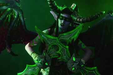 Demon Hunter Demon Cosplay on Black Background in Green Light