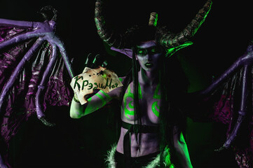 Demon Hunter Demon Cosplay on Black Background in Green Light