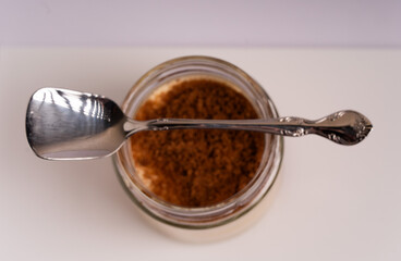 Elegant Jar of Dessert with Dark Sugar and Decorative Spoon