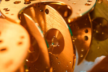 Intricate craftsmanship reveals stunning watch mechanism bases in a vibrant metalworking workshop
