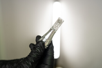 Microneedle RF lifting procedure. A cosmetologist performs a facial rejuvenation procedure on a...