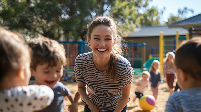 A smiling preschool teacher playing with a group of children in an outdoor playground, children running, laughing, playing with a ball, bright and natural sunlight, safe and fun environment