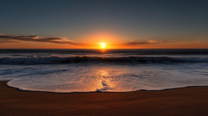 Fototapeta premium Golden sunset over the ocean. Waves crashing on the beach