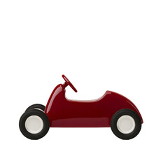 Red toy car isolated on black. Nostalgic plaything with white tires and simple design, evoking childhood fun and imagination.