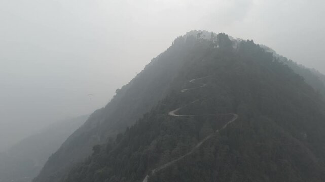 Drone shot 4k. Aerial view of the foggy day in Pelling, Sikkim. Sikkim mountains. Northern India. Indian Mountain. D Log Footage. Bird eye View. Travelling Northeast. Cinematic Paragliding Video 