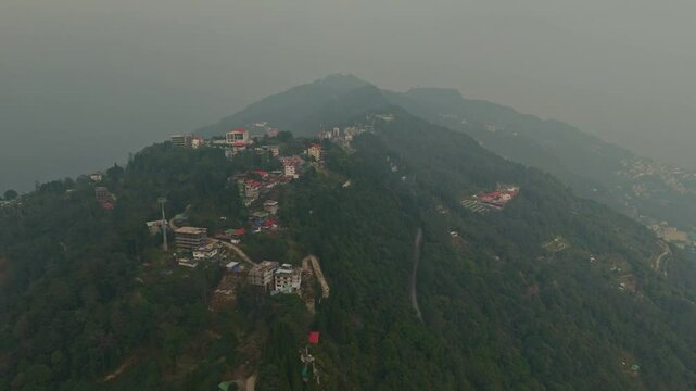 Aerial, drone shot 4k. Aerial view of the foggy day in Pelling, Sikkim. Northern India. Indian Mountain. D Log. Bird eye View. Travelling Northeast Video. Indian mountain village. IN front of Skywalk.