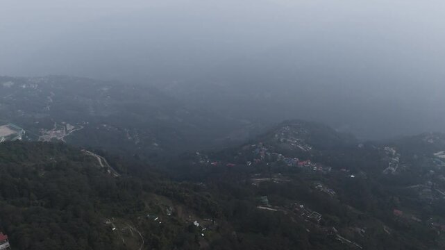 Aerial, drone shot 4k. Aerial view of the foggy day in Pelling, Sikkim. Northern India. Indian Mountain. D Log. Bird eye View. Travelling Northeast Video. Indian mountain village. IN front of Skywalk.