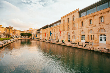 Spectacular view of the moored sailing yachts in seaport Vittoriosa and St. Lawrence's Catholic Church. Location place Birgu harbour, Malta, Europe. Photo wallpapers. Discovery the beauty of earth.