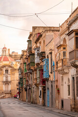 The nearly empty St. Margaret Street in Cospicua. Perhaps a reflection of the times. Triq Santa Margerita, Bormla.Cospicua,View at St Paul's Church Cospicua through a street with many colorful bay 
