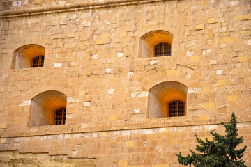 Fort Saint Michael - Senglea.The old dock building at Bormla (Cospicua) waterfront. Malta. The old dock buildings at Bormla (Cospicua) waterfront with the Fort St. Michael Clock Tower on the backgroun