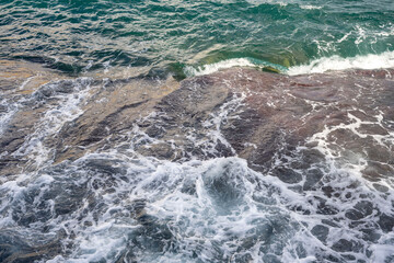 High Angle Shot of a Sea Waves Crashing on the Rocks. Rocks by the Sea North of Malta.