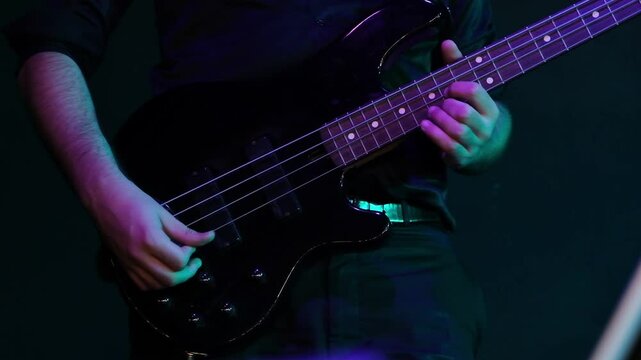 bass guitarist plays guitar on stage