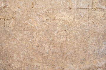 Processed collage of ancient yellow block wall texture. Background for banner, backdrop or texture for 3D mapping.A rectangular slab of light sandstone against the background of stone fragments as the
