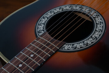 Obraz premium Acoustic guitar close up of sound holes and fret board
