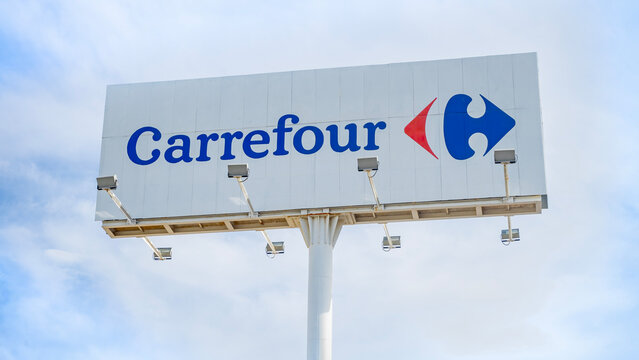 Dos Hermanas, Seville, Spain, 02-15-2025; Close-up of a Carrefour supermarket logo sign on advertising billboard.
