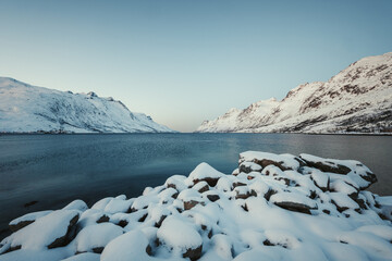 Landscape shot of Ersfjord arctic fjord on sunny winter day near Tromso, Norway. © Benjamin