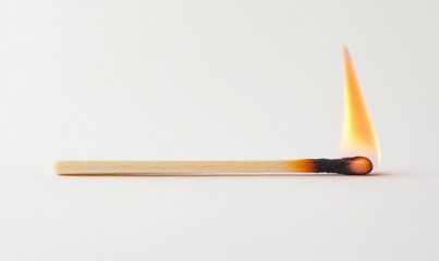A matchstick is lit and the flame is burning