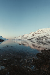 Snowy mountains of Ersfjord with reflection in arctic ocean near Tromso, Norway. © Benjamin