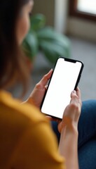 Woman sitting in front of a blank mobile phone screen with fingers on keyboard, focus, computer