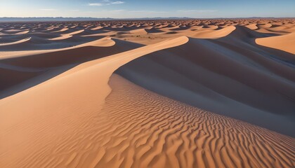 A panoramic shot captures a vast desert landscape under a clear blue sky dotted with wispy clouds