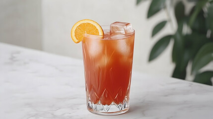 Refreshing iced cocktail garnished with orange, served on marble surface, blurred plants in background. Perfect for bar menus or drink recipes
